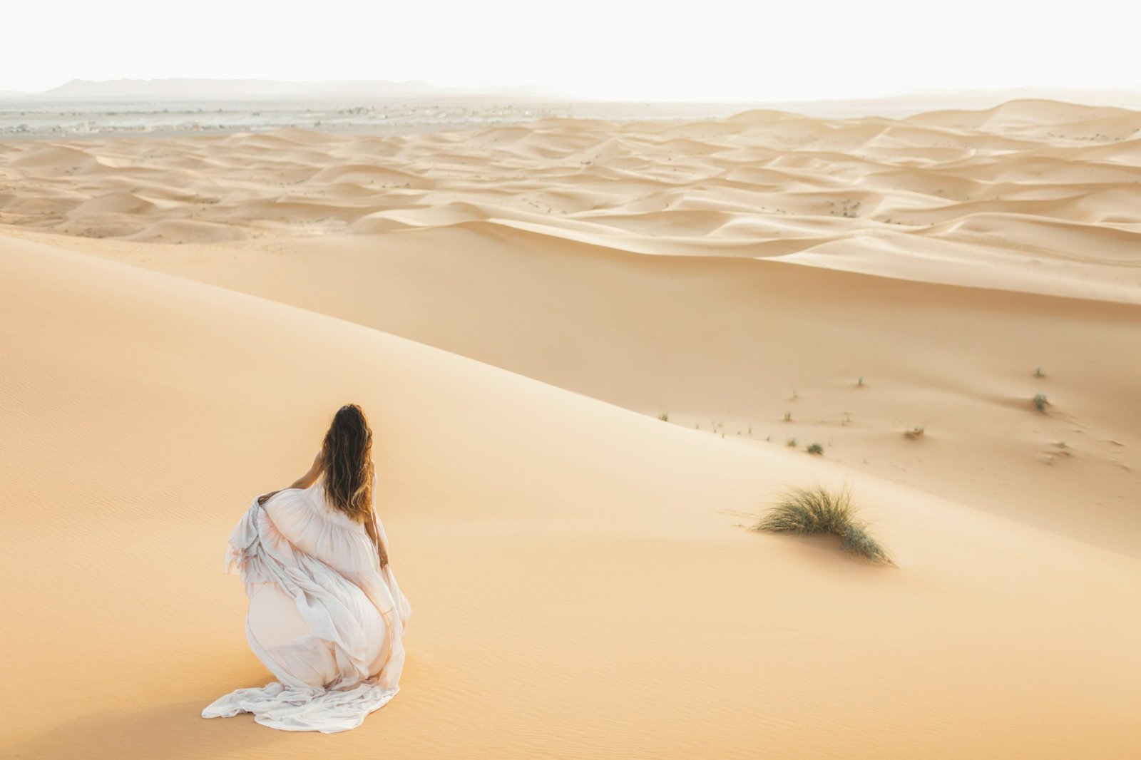 Portrait of bride woman in amazing wedding dress in Sahara desert, Morocco. Warm evening light