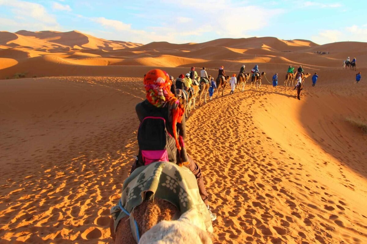 Things to do in Merzouga include an unforgettable camel ride through the golden sand dunes of the Sahara desert, offering stunning views, authentic desert experiences, and magical sunsets. This top Merzouga activity is a must during any Morocco desert Merzouga tour or camp stay.