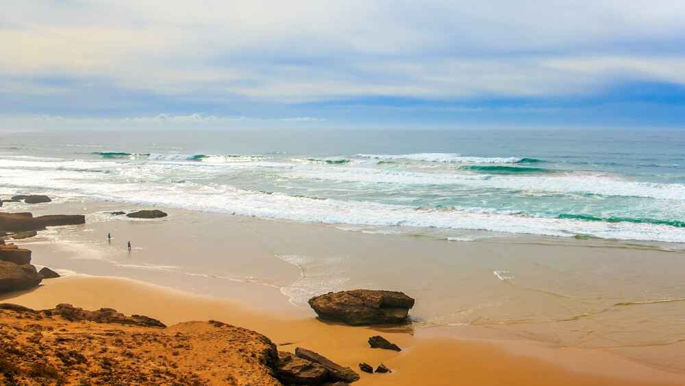 Things to do in Essaouira include walking along Essaouira beach, perfect for fresh ocean air and rejuvenation. This activity is ideal for unwinding and is among the best answers for “is Essaouira worth visiting” and “what to do in Essaouira.”